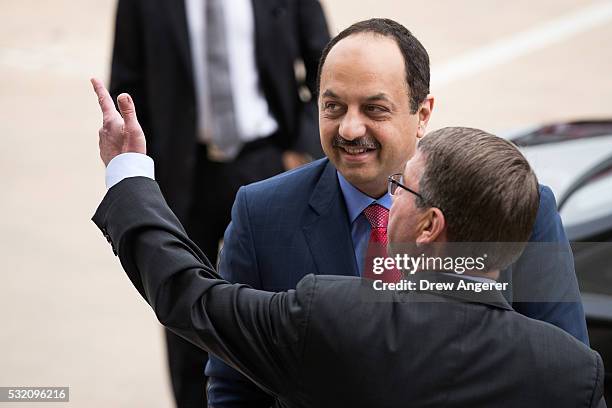 Secretary of Defense Ash Carter speaks with Qatar's Minister of State for Defense Affairs Dr. Khalid bin Mohammed al Attiyah during an honor cordon...