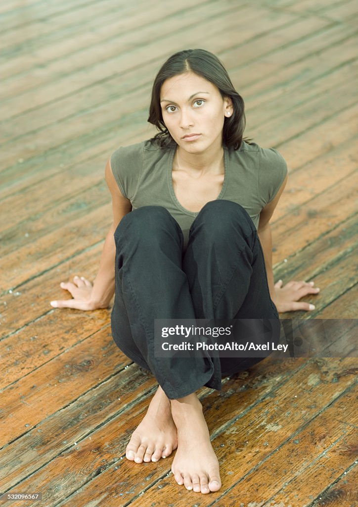 Woman sitting on floor, portrait