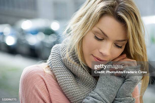 woman dressed warmly in knit gloves and scarf - fingerless glove stock-fotos und bilder