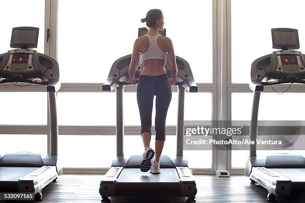 woman jogging on treadmill at gym - トレッドミル　女性 ストックフォトと画像