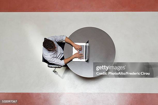 college student using laptop computer alone in breakroom - elevated view circle stock pictures, royalty-free photos & images