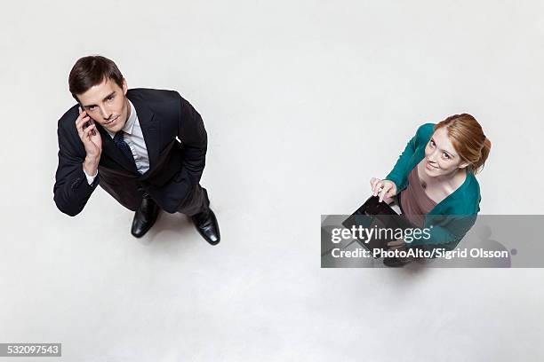 professionals standing in lobby using cell phone and digital tablet, overhead view - person look up from above stock pictures, royalty-free photos & images