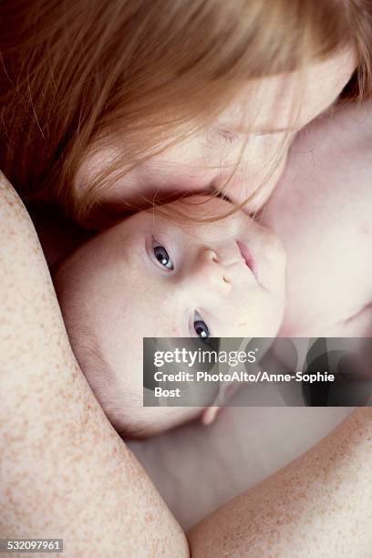 mother nuzzling baby, overhead view - anne sophie mutter stock-fotos und bilder