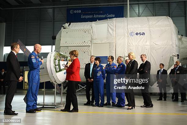 German Chancellor Angela Merkel and German ESA astronaut Alexander Gerst stand at the Orion spacecraft during a visit at the training unit of the...