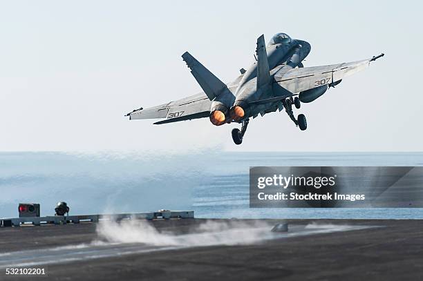 an f/a-18c hornet launches from the flight deck of uss harry s. truman. - uss harry s truman stock pictures, royalty-free photos & images