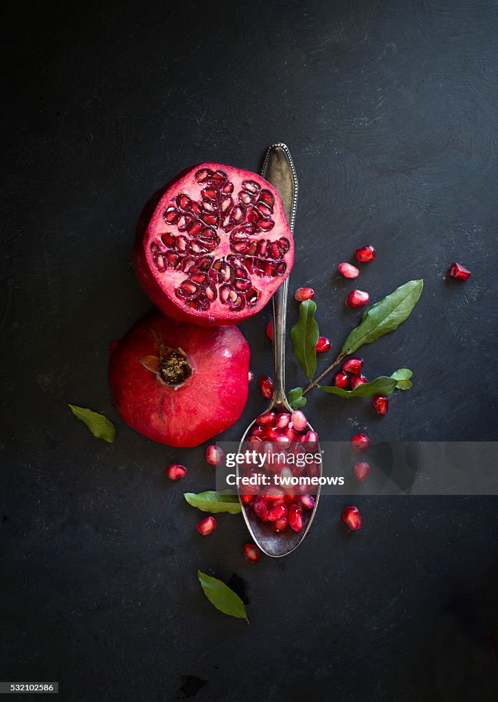 Pomegranate on black textured background.