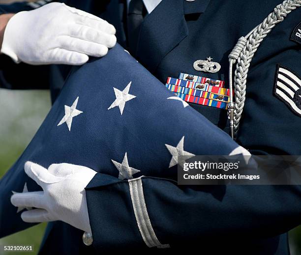 u.s. honor guard performs a flag folding demonstration. - us military emblems photos et images de collection