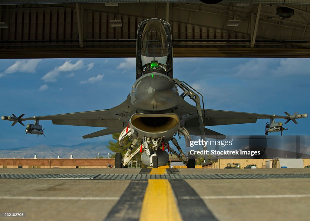 Crew members prepare an F-16 Fighting Falcon for a training sortie.