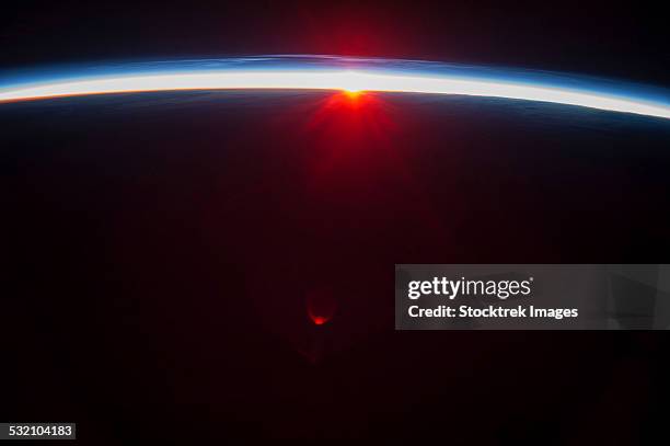 a sunset over the aleutian islands, with noctilucent clouds. - troposphere stock pictures, royalty-free photos & images