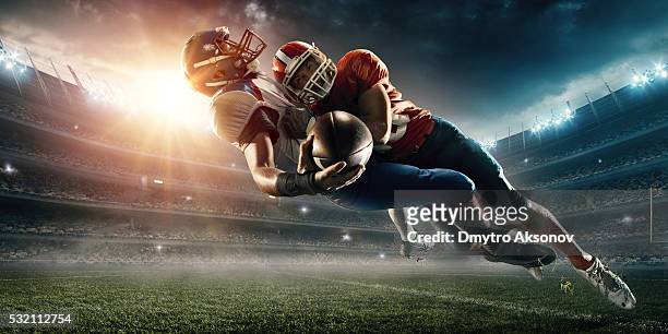 american football player being tackled - tackling stock pictures, royalty-free photos & images