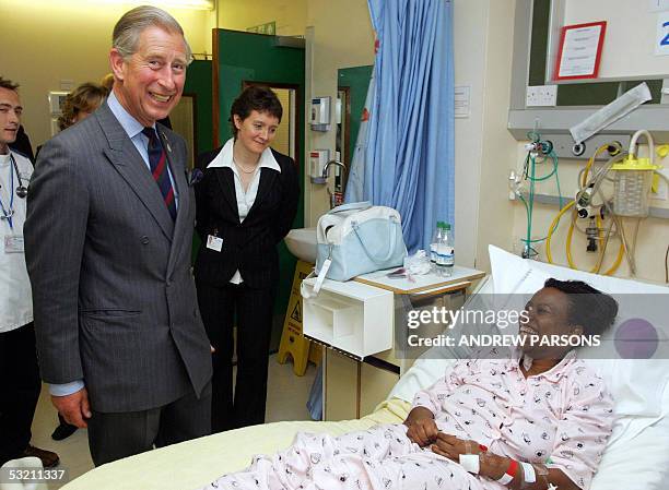 London, UNITED KINGDOM: The Prince Of Wales talks to Cynthia Bobb-Semple, one of the victims of the bomb blasts which hit London yesterday, at St...