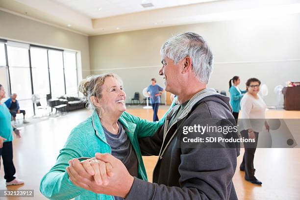 senior husband and wife take dance lessons - older couple ballroom dancing stock pictures, royalty-free photos & images