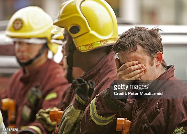 Fireman rubs his face as he waits outside King's Cross railway station where 21 people were killed in a terrorist attack - July 8, 2005 London. At...