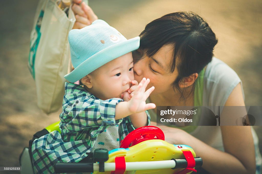 Mother kissing son (6-11 months)