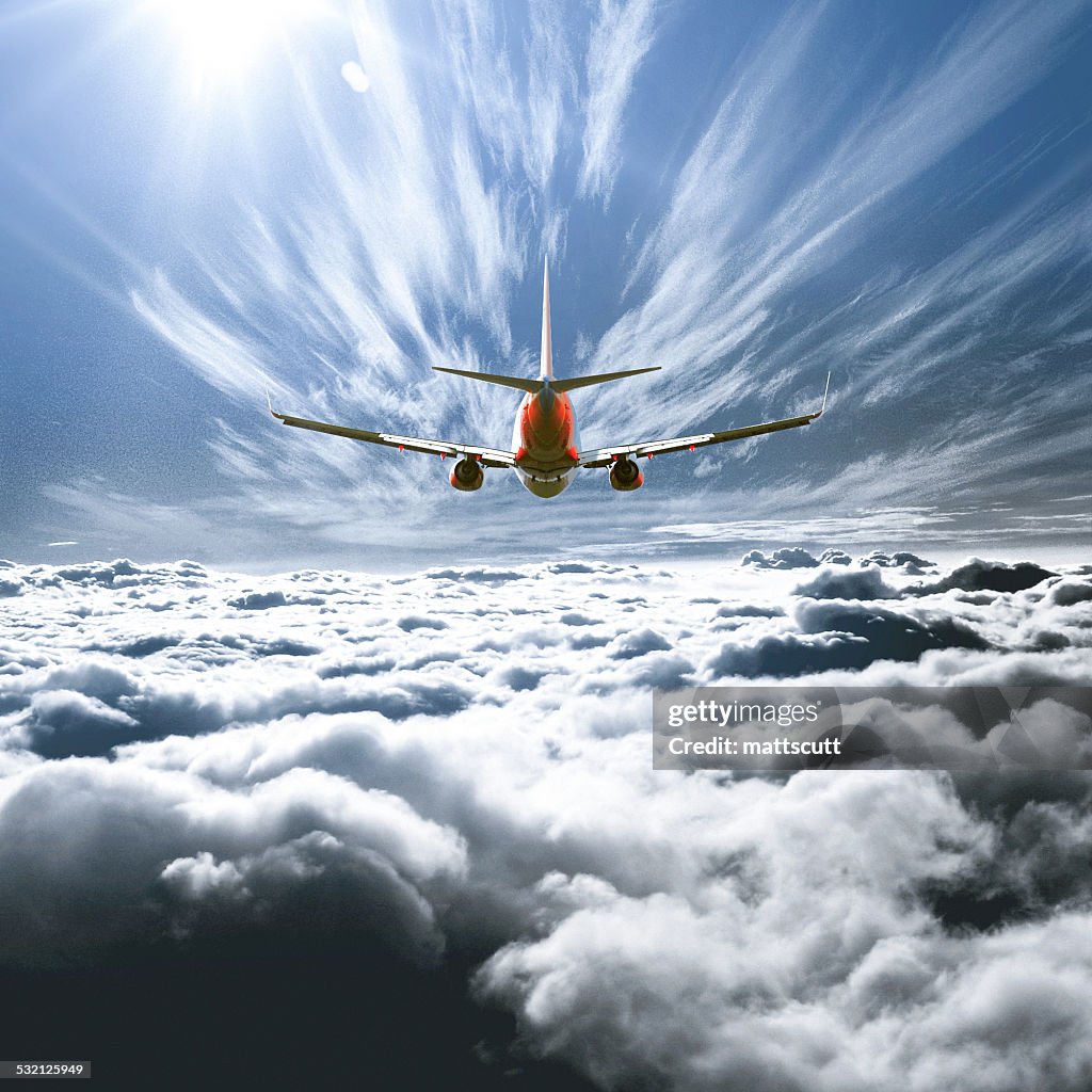 Airplane flying above the clouds