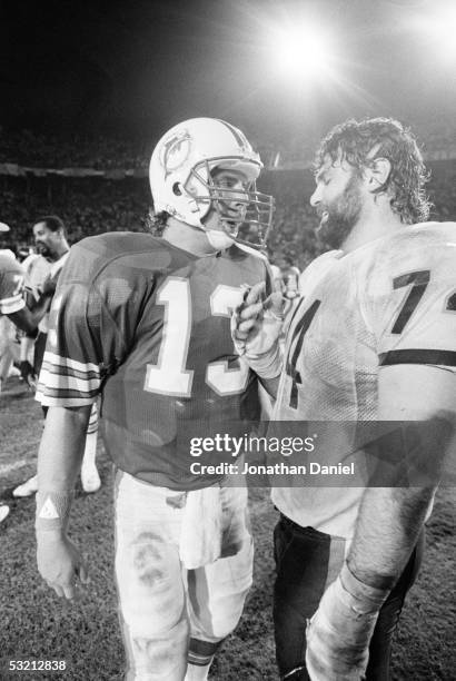 Dan Marino of the Miami Dolphins talks to Jim Covert of the Chicago Bears following the game at the Orange Bowl on December 2, 1985 in Miami,...