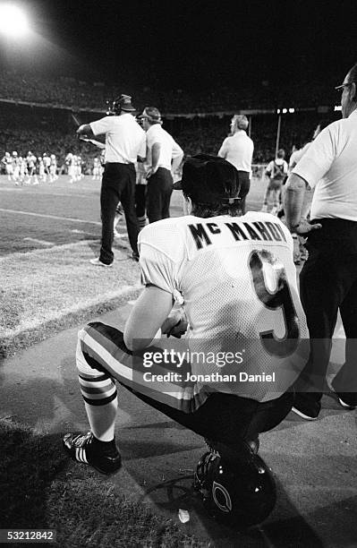 Jim McMahon of the Chicago Bears sits on the sideline during the game against the Miami Dolphins at the Orange Bowl on December 2, 1985 in Miami,...