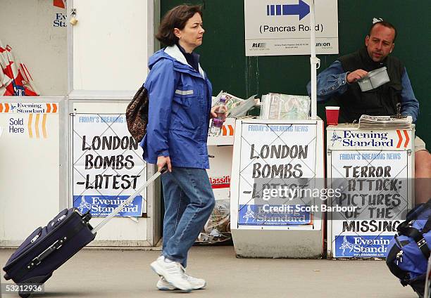 Woman walks past a newstand near King's Cross Station on July 8, 2005 in London, England. More than 50 people were killed and 700 injured during a...