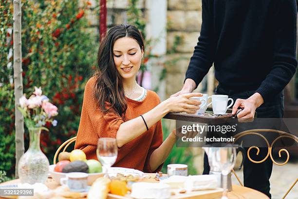 young french girl eating in the garden home - huishoudelijke dienstverlening stockfoto's en -beelden