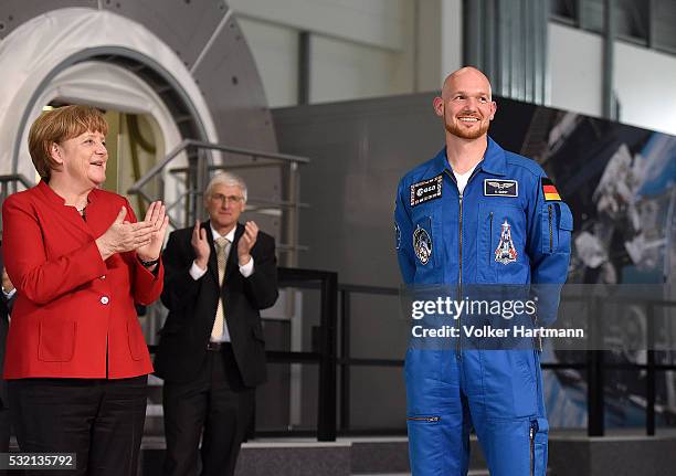 The German Chancellor Angela Merkel applauds german astronaut Alexander Gerst in the astronauts training hall during a visit of the European...