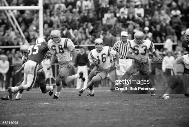 American college football player Gary Beban , quarterback for UCLA, looks for an opening as he runs with the ball during game against University of...