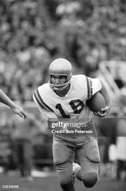 American college football player Gary Beban , quarterback for UCLA, runs with the ball during game against University of Pittsburgh, Pittsburgh,...