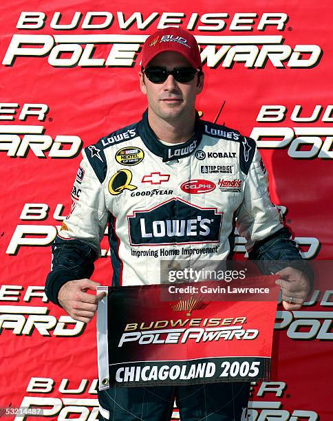 Jimmie Johnson, driver of the Lowe's Chevrolet, poses with the "Pole Award" after qualifying for pole position during the NASCAR Nextel Cup Series...