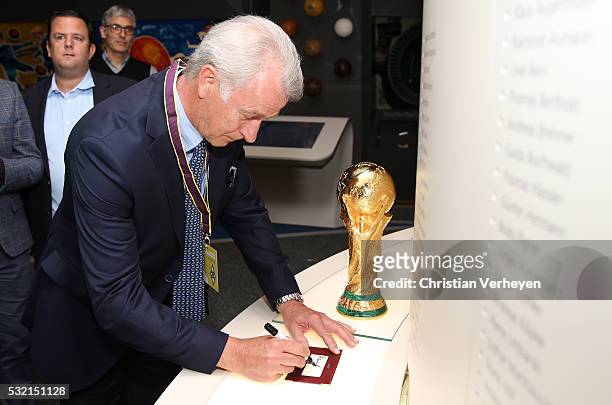 Vice President Rainer Bonhof of Borussia Moenchengladbach sign the wall of the world champions during he visit the Fifa Museum at day three of...