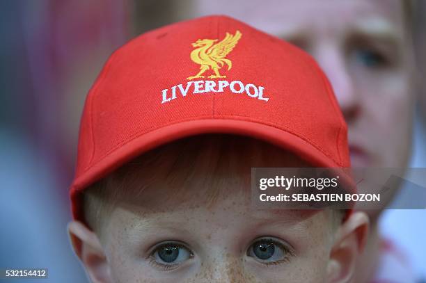 Boy wears a Liverpool cap as he attends the UEFA Europa League final football match between Liverpool FC and Sevilla FC at the St Jakob-Park stadium...