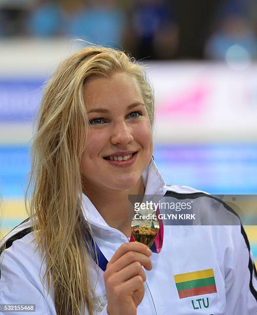 Gold medalist Lithuania's Ruta Meilutyte poses for a photograph after the final of the women's 100m Breaststroke swimming event on Day 10 of the...