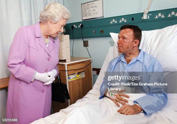 Queen Elizabeth II, The Queen, chats with Bruce Lait about damage to his hearing caused when he was caught in one of the explosions on the...