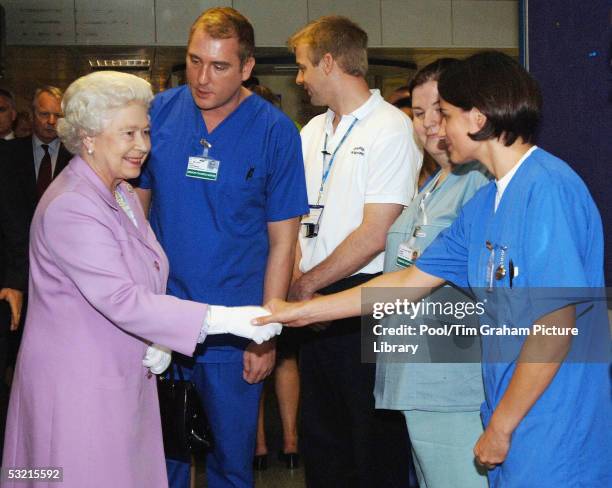 Queen Elizabeth II, The Queen, is introduced to Accident and Emergency staff by Senior Charge Nurse Paul Courtman during her visit to the Royal...