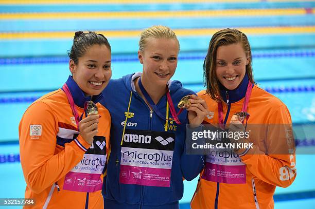 Gold medalist Sweden's Sarah Sjoestroem poses for a photograph with silver medalist Netherland's Ranomi Kromowidjojo and bronze medalist Netherland's...