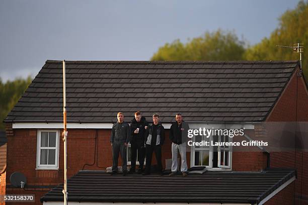 Fans take up any available vantage point to watch the action during the Sky Bet League Two play off, Second Leg match between Accrington Stanley and...