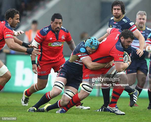 Alex Shaw of Doncaster Knights tackles James Phillips of Bristol Rugby during the Greene King IPA Championship Play Off Final match First Leg between...