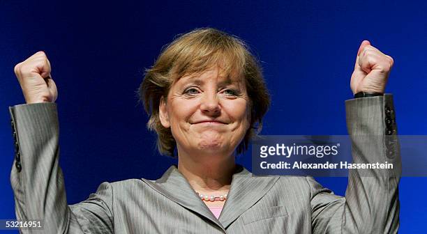 Angela Merkel, head of the opposition Christian Democrats, the CDU, raises her fists at the Lower Saxony Christian Democratic Party's annual general...