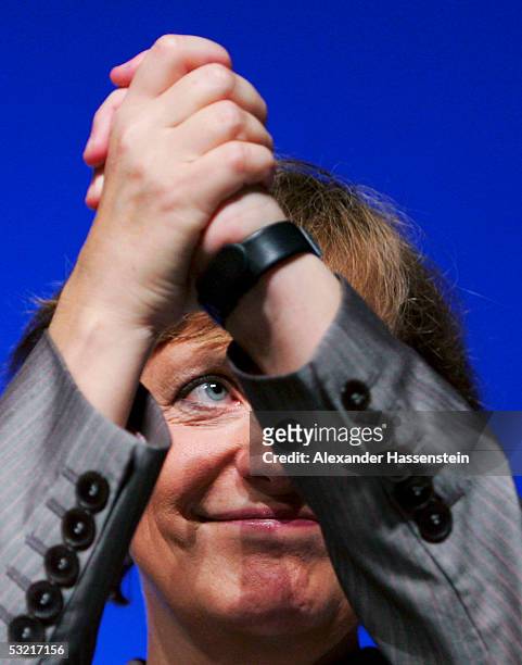 Angela Merkel , head of the opposition Christian Democrats, the CDU, raises clasps her hands during the Lower Saxony Christian Democratic Party's...