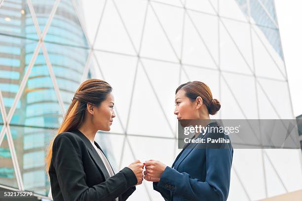 businesswomen exchanging business cards, hong kong, china, asia - two international finance center stock pictures, royalty-free photos & images