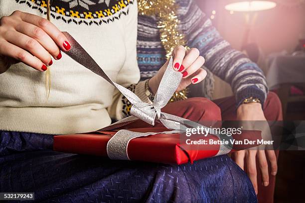 woman unpacking present, close up. - christmas gift stock pictures, royalty-free photos & images