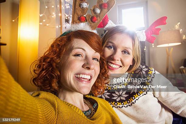 friends taking selfie at christmas celebration. - woman selfie portrait stock pictures, royalty-free photos & images