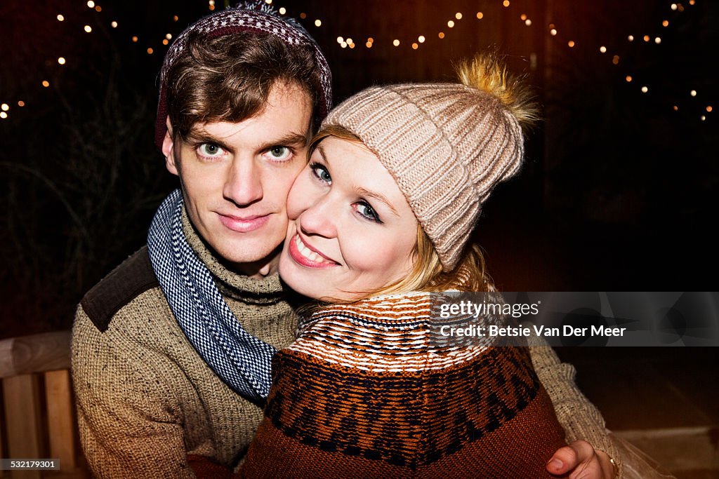 Portrait of couple with wooly hats outdoors.