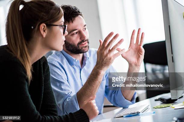 meeting at the office - explaining stock pictures, royalty-free photos & images