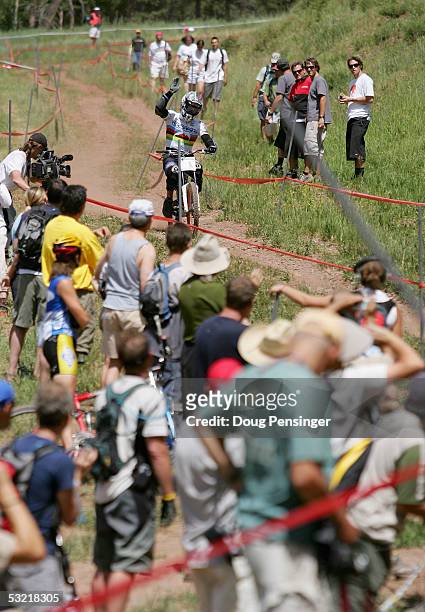 Reigning Downhill World Champion Fabien Barel of France acknowledges the crowd as he flatted during the finals of the Men's Downhill Event at the UCI...