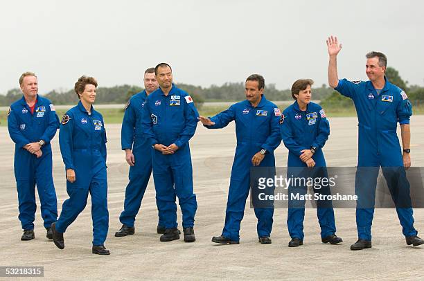 Space Shuttle Discovery astronauts wave to the media after making a statement after they arrived via a Gulfstream Jet at the Kennedy Space Center's...