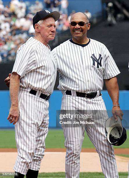 Hall of Famers Whitey Ford and Reggie Jackson stand on the field for introductions during New York Yankees 59th annual old timers day before the...