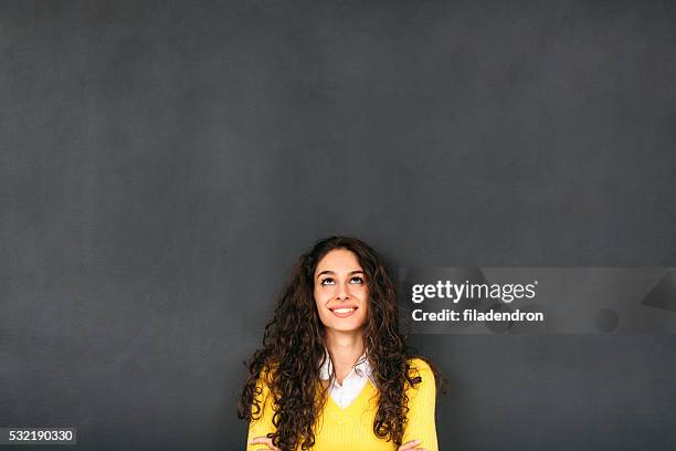 woman in front of blackboard - woman looking up bildbanksfoton och bilder