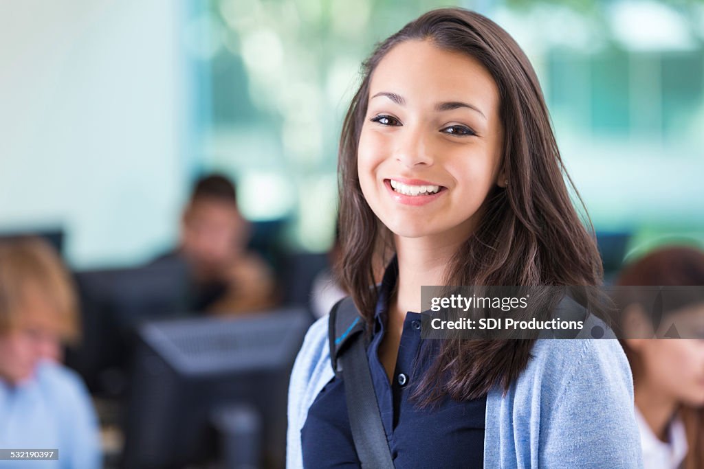 Beautiful teen private school student in computer lab