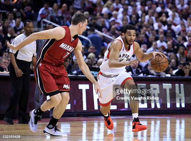 Cory Joseph of the Toronto Raptors dribbles the ball as Goran Dragic of the Miami Heat defends in the first half of Game Seven of the Eastern...