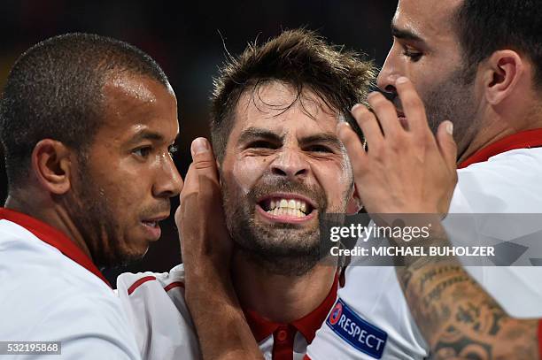 Sevilla's Spanish defender and captain Coke celebrates with Sevilla's French defender Adil Rami and Sevilla's Brazilian defender Mariano Ferreira...