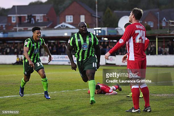 Adebayo Akinfenwa of AFC Wimbledon celebrates after scoring a goal to level the aggregate scores at 2-2 during the Sky Bet League Two play off,...